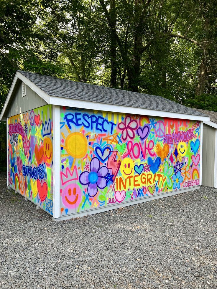 a colorful painted storage shed with the word respect written on it