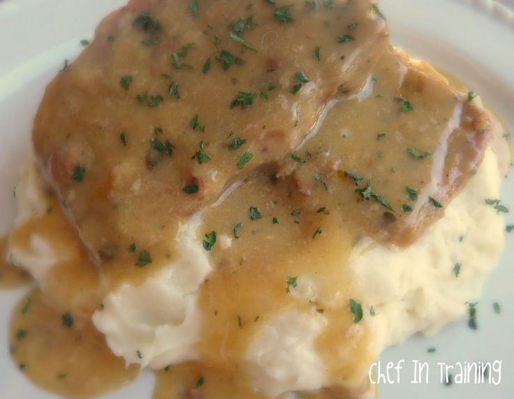 mashed potatoes covered in gravy on a white plate