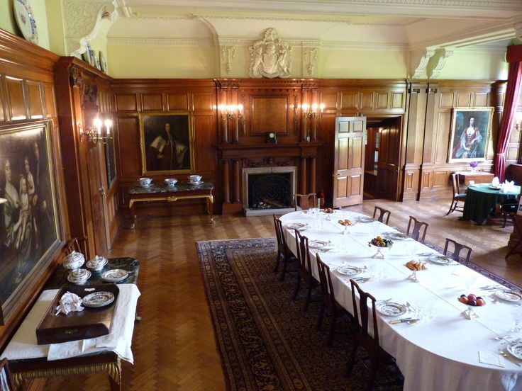 the dining room is set with white tablecloths