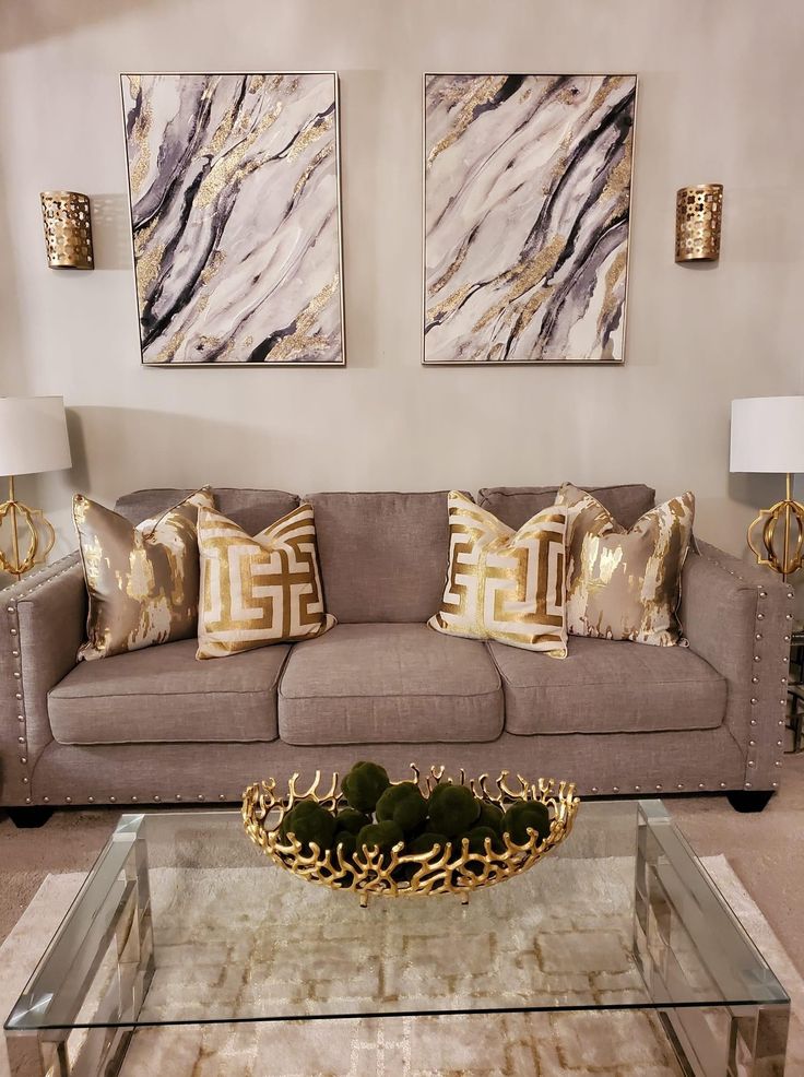 a living room filled with furniture and pillows on top of a glass topped coffee table