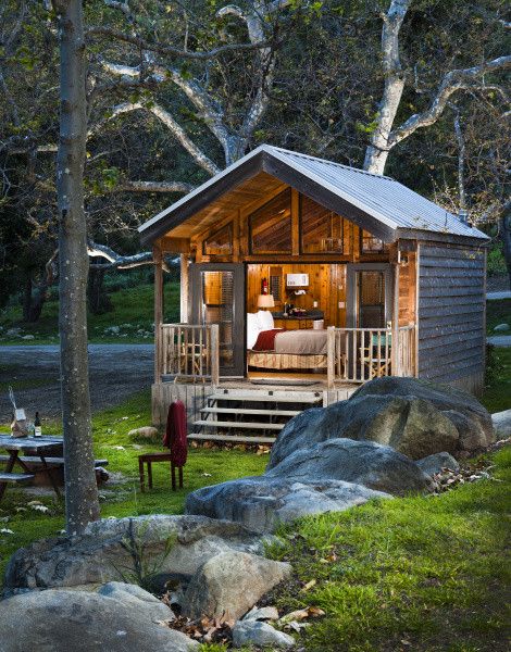 a small wooden cabin in the woods