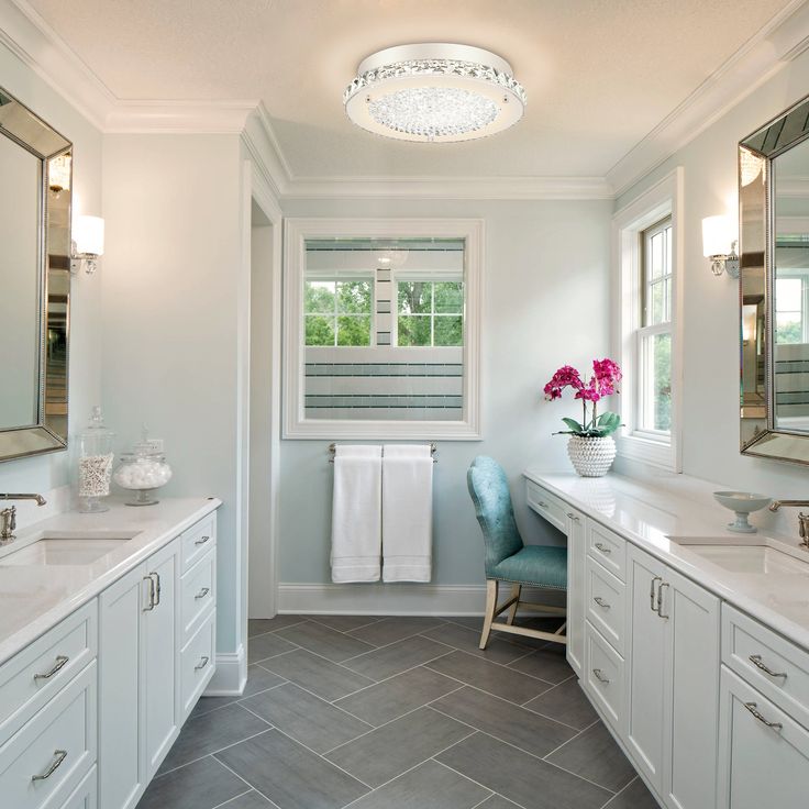 a large bathroom with two sinks and mirrors