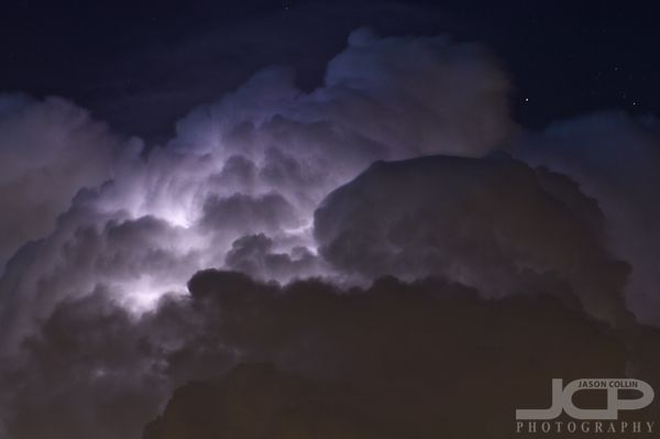 a large cloud with lightning in the sky