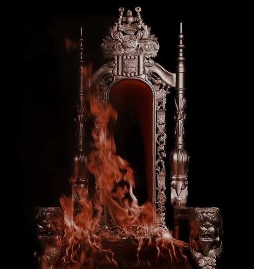 an ornate chair with flames in front of it