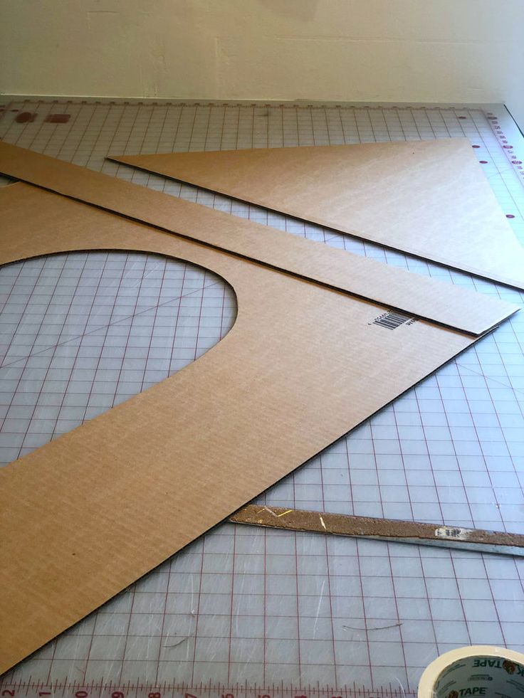 three pieces of cardboard cut out to look like shapes on a table with tape and scissors