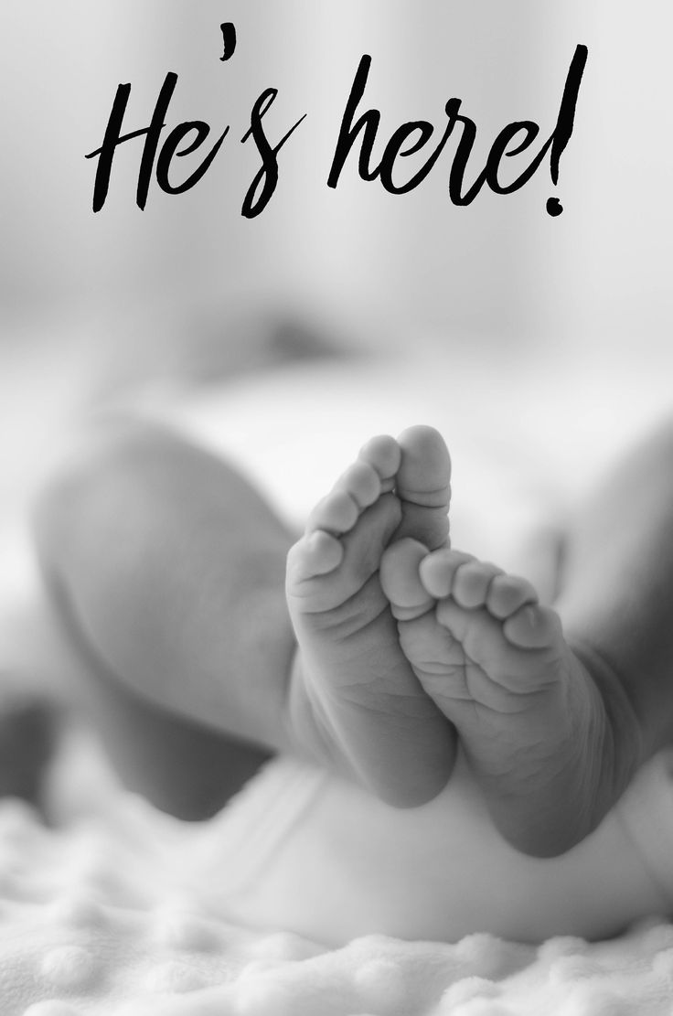 a black and white photo of a baby's feet