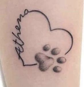 a dog paw and heart tattoo with the word love written on it's side