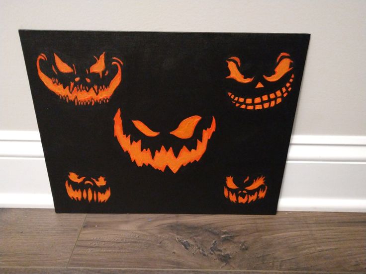 an image of halloween pumpkins painted on the side of a wall with scary faces