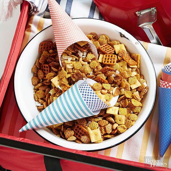 a bowl filled with cereal and cones next to an ice cream cone on top of a table