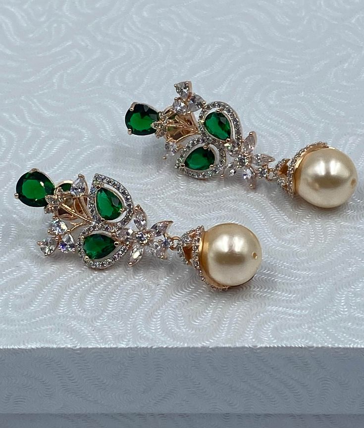 Gorgeous Emerald Green earrings with AD to dazzle your looks with pearl drops ! Elegant Pearl Drop Earrings For Festive Occasions, Elegant Green Crystal Earrings For Festive Occasions, Elegant Green Teardrop Earring (single), Elegant Green Drop Earrings, Elegant Festive Pearl Drop Earrings, Elegant Green Teardrop Single Earring, Green Pearl Earrings For Wedding, Glamorous Drop Pearl Drop Earrings, Elegant Teardrop Pearl Earrings For Festive Occasions