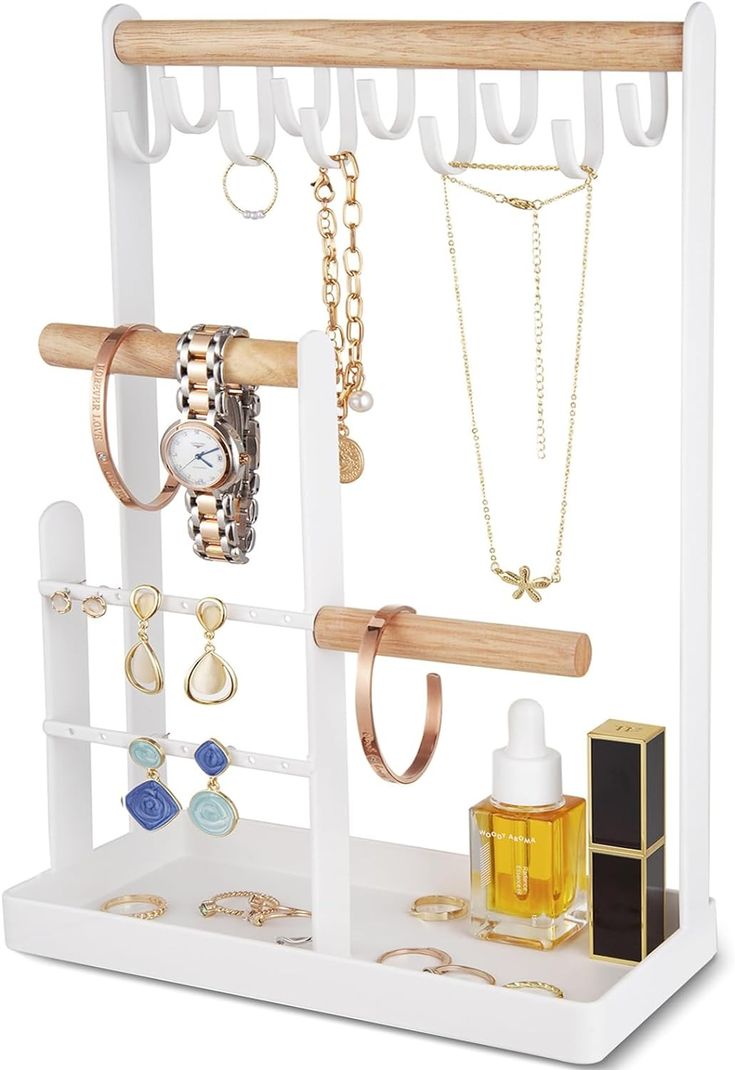 a white jewelry holder with several necklaces and rings