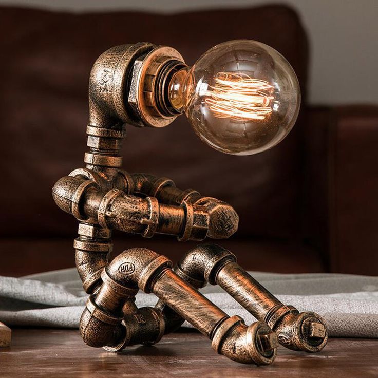 a lamp that is sitting on top of a wooden table in front of a couch