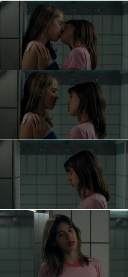 two young women are kissing each other in the bathroom