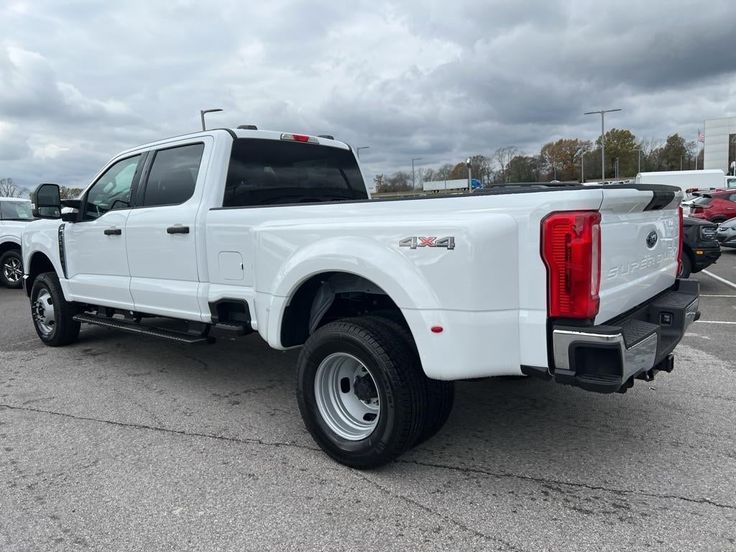 a white pickup truck parked in a parking lot