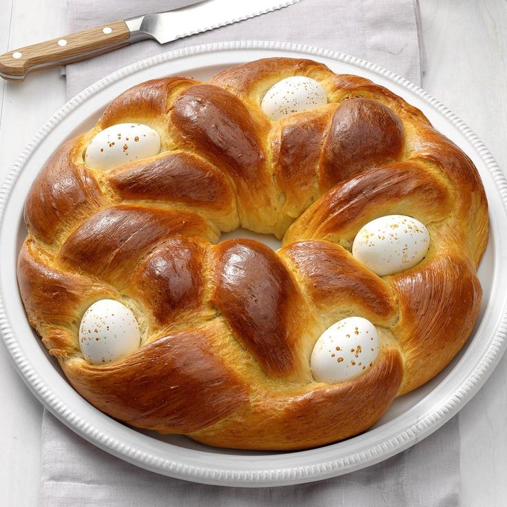 a white plate topped with a pastry covered in eggs