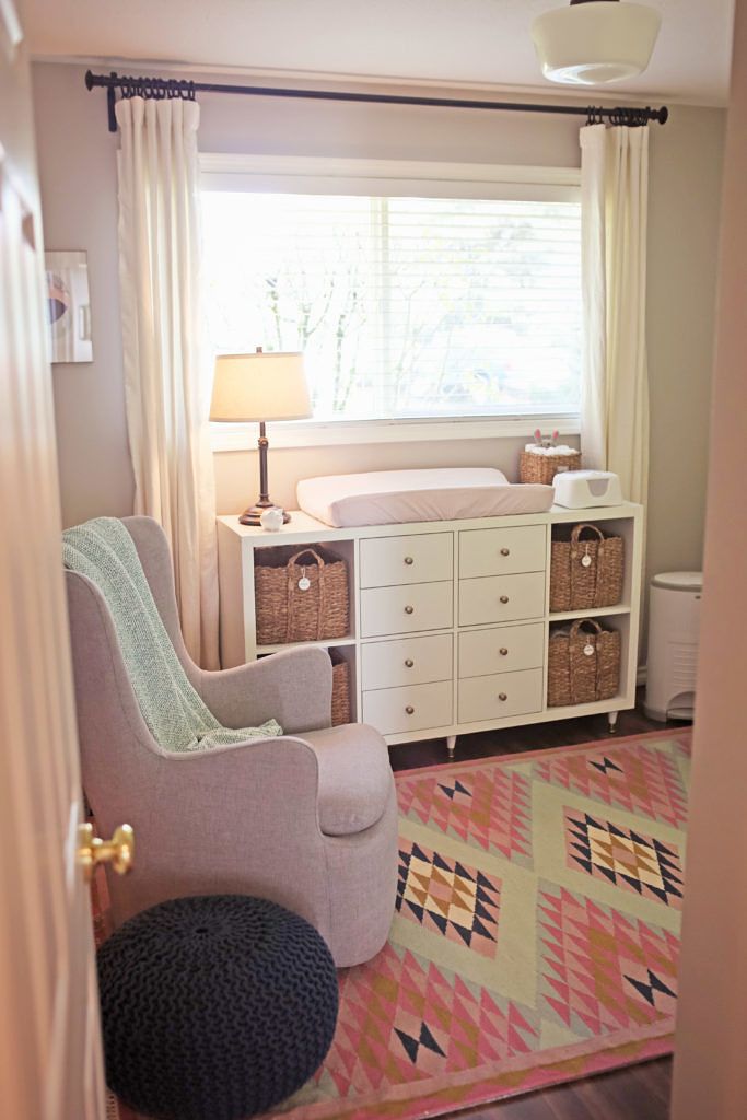 a baby's room with a crib, dresser and changing table in it