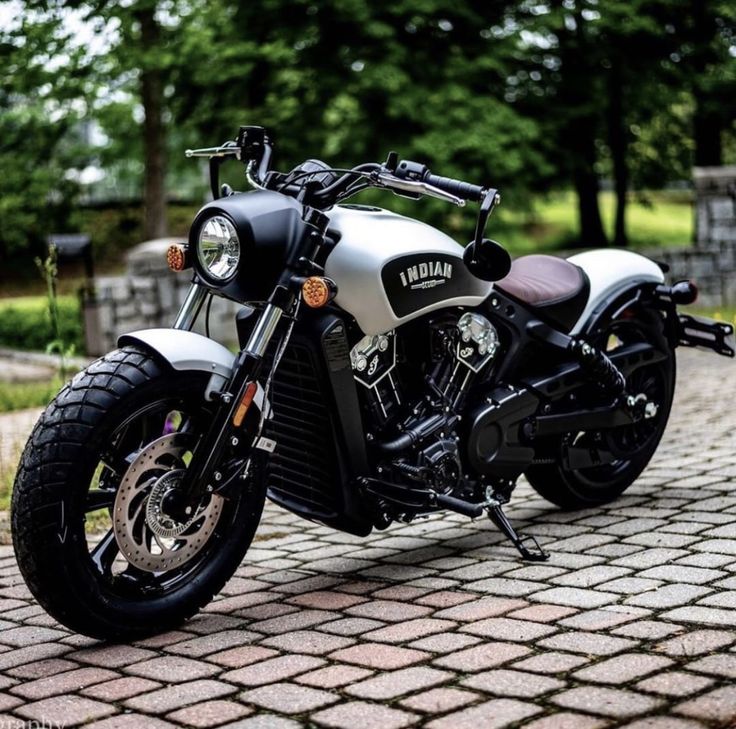 a motorcycle parked on top of a brick road