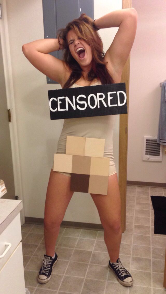 a woman holding a sign that says censored in front of her head and chest