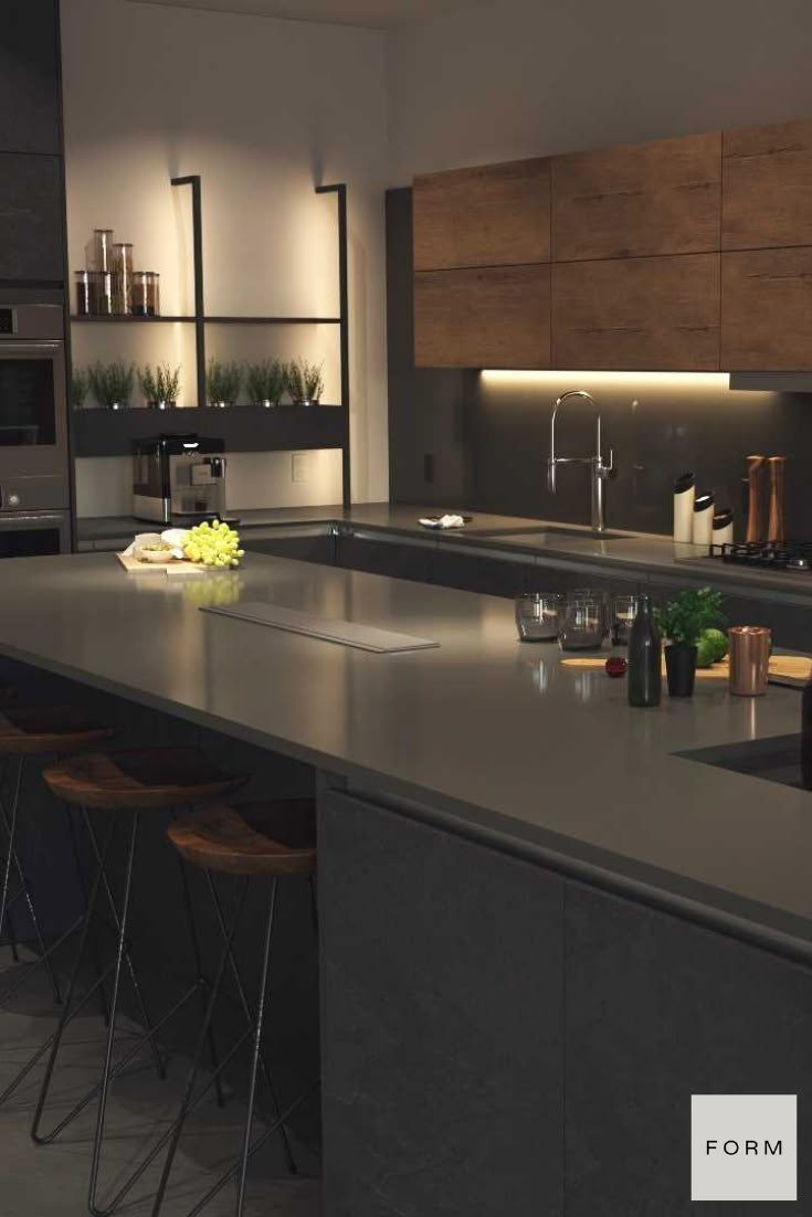 a modern kitchen with an island counter and bar stools in the center, lighted by recessed lighting