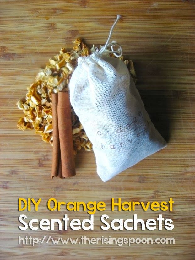 an orange harvest bag next to two cinnamon sticks on a wooden surface with the words diy orange harvest scented sachets