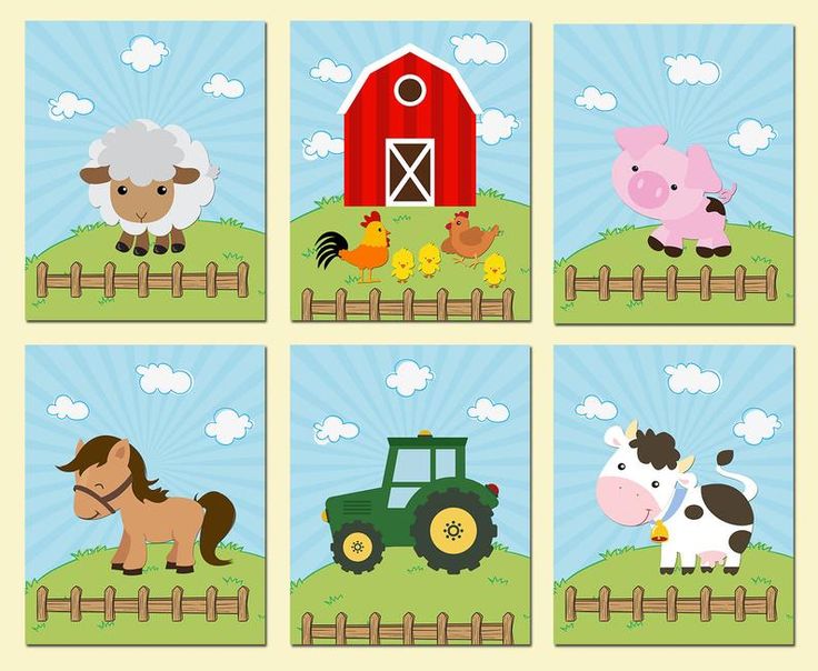 four farm animals are standing in the grass near a fence and a red barn with a green tractor