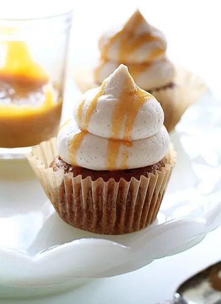 cupcakes with eggnog buttercream frosting are on a plate