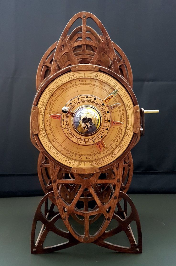 a wooden clock sitting on top of a table