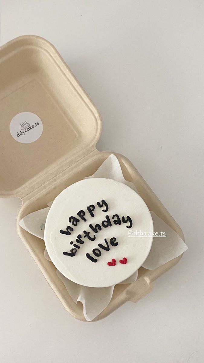 a birthday cake in a box with the words happy birthday love written on it's side