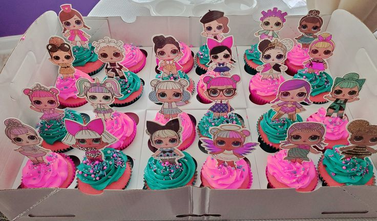 a box filled with cupcakes covered in pink and blue frosting