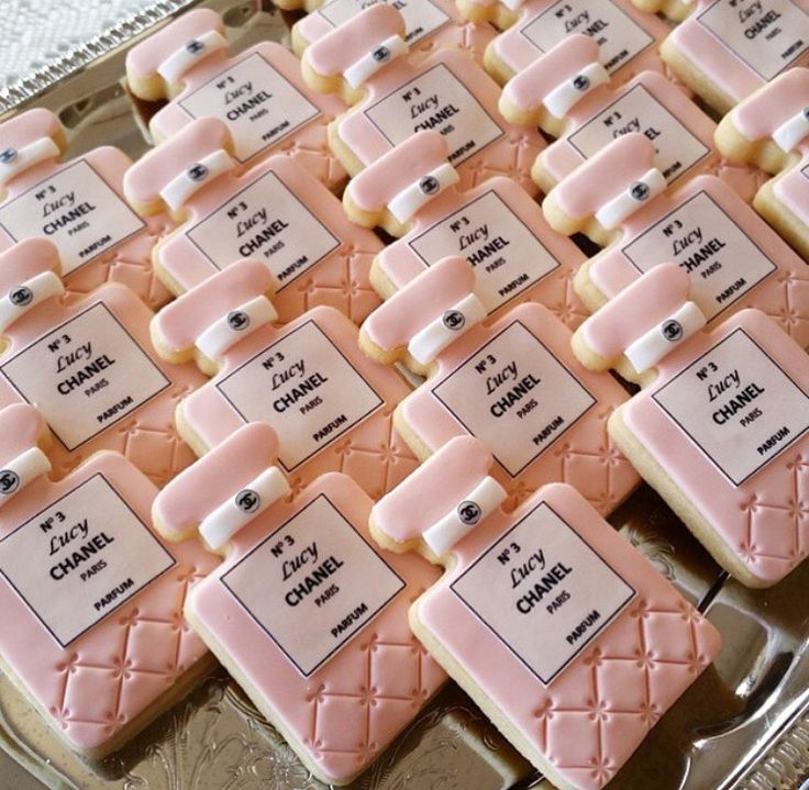 many cookies are arranged in rows on a silver platter, with labels that read family and friends