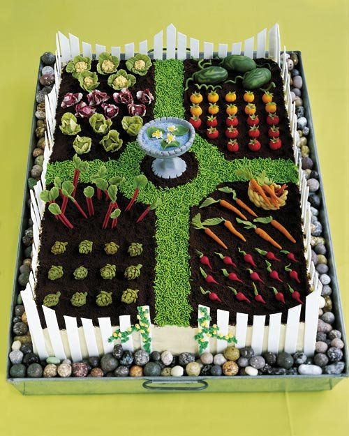 a vegetable garden is displayed in a box with rocks and grass on the bottom floor