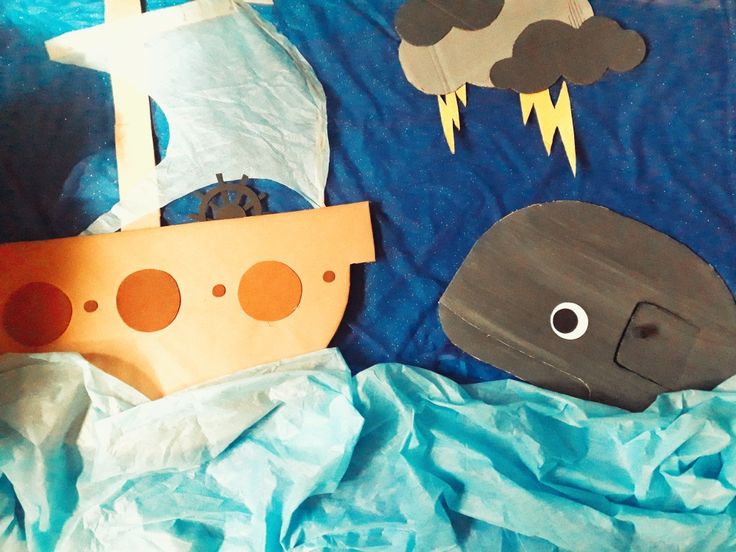 an image of a paper boat with clouds and lightning on it's side next to a pirate ship