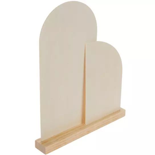 two white heart shaped paper holders on a wooden stand