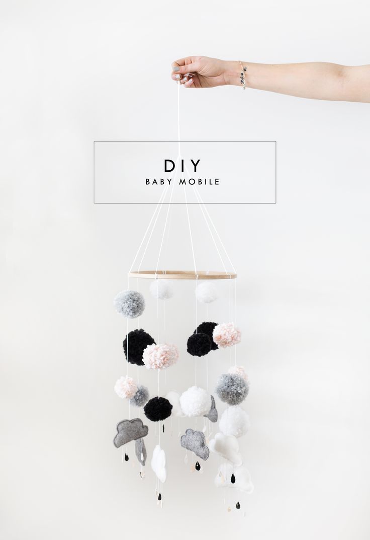 a mobile with pom poms hanging from it's sides and the words diy above it