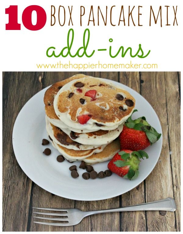 some pancakes on a plate with strawberries and chocolate chips