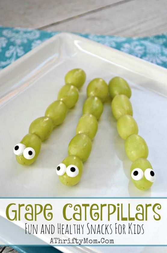 grape caterpillars on a white plate with green grapes and googly eyes