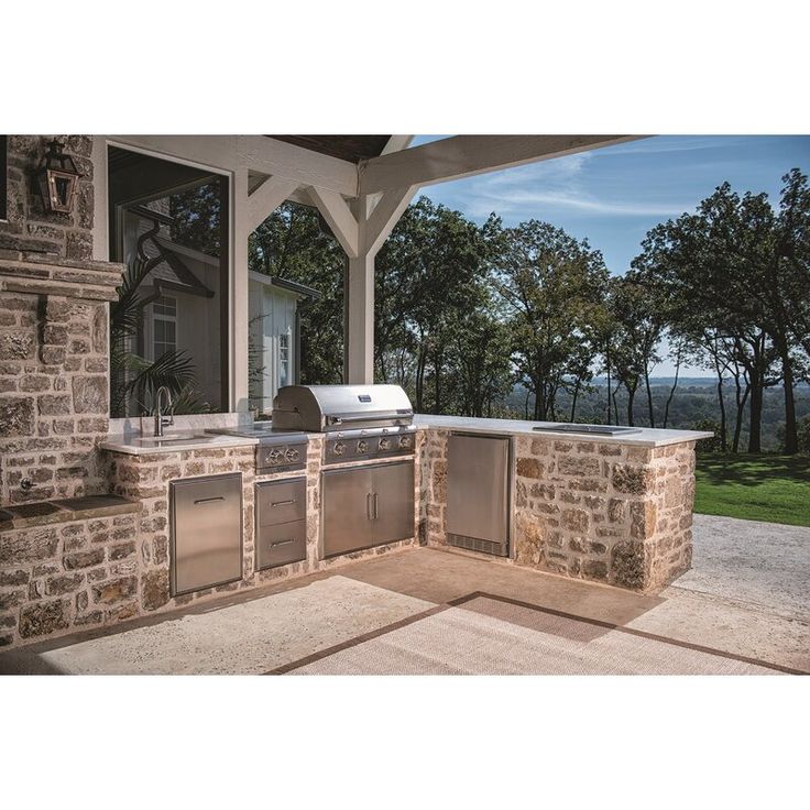 an outdoor kitchen with grill and sink