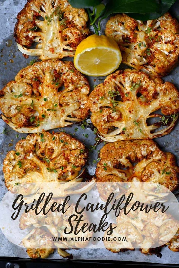 grilled cauliflower steaks with lemon wedges and parsley on the side