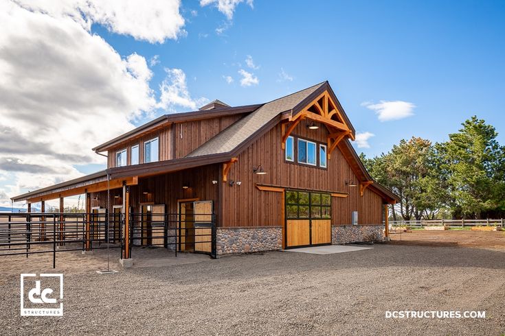 a horse barn is shown in the middle of an open field