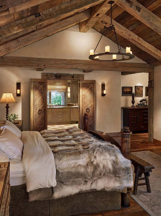 a large bed sitting under a wooden beam in a bedroom