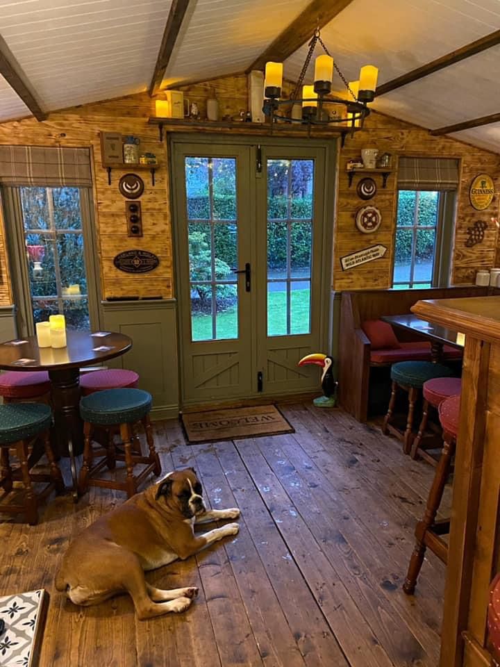 a dog is laying on the floor in a room with wooden floors and green doors