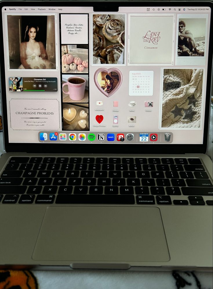 an open laptop computer sitting on top of a bed