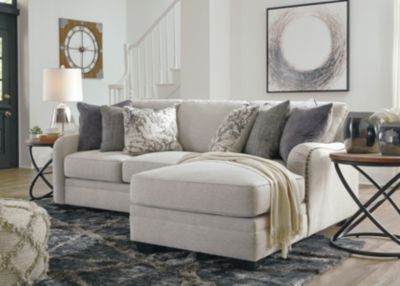 a living room scene with focus on the couch and chair, coffee table and rug