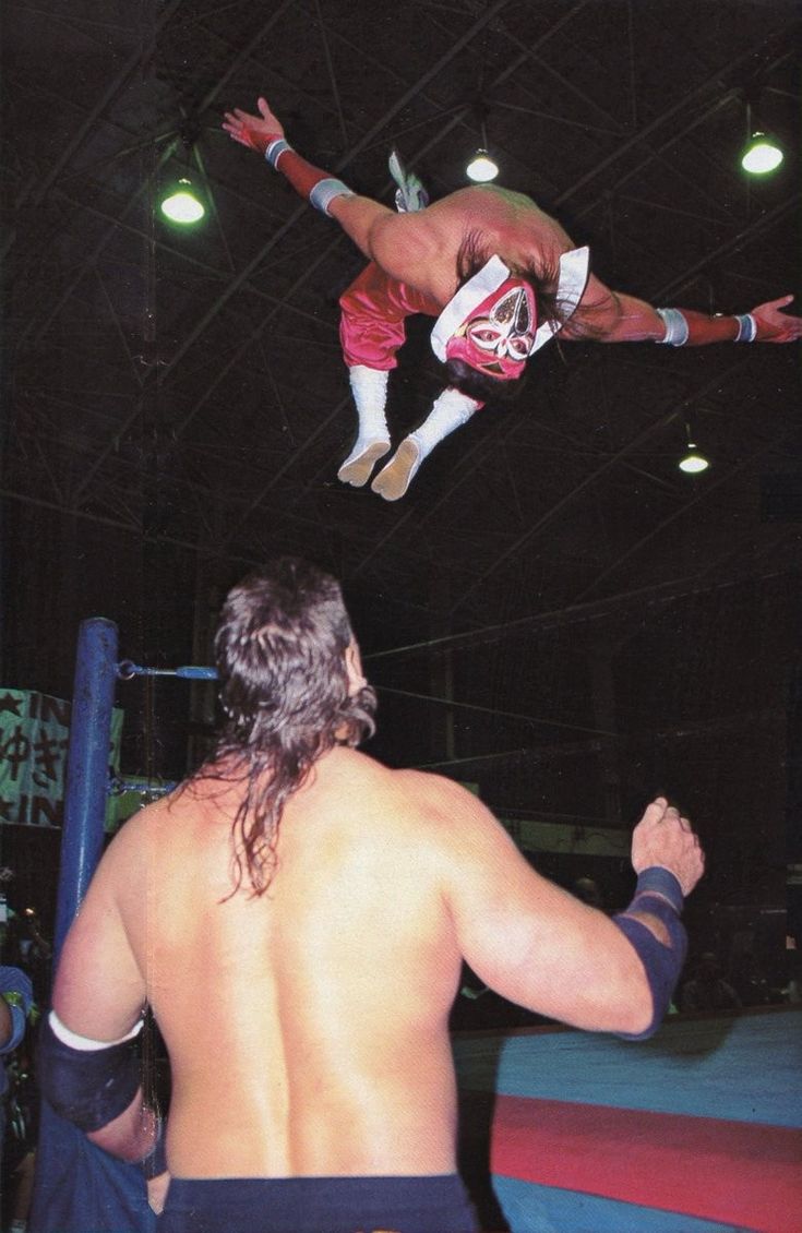 two men are in the air while one man is on top of an obstacle course