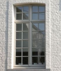 a white brick building with an open window