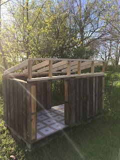 a wooden outhouse sitting in the grass