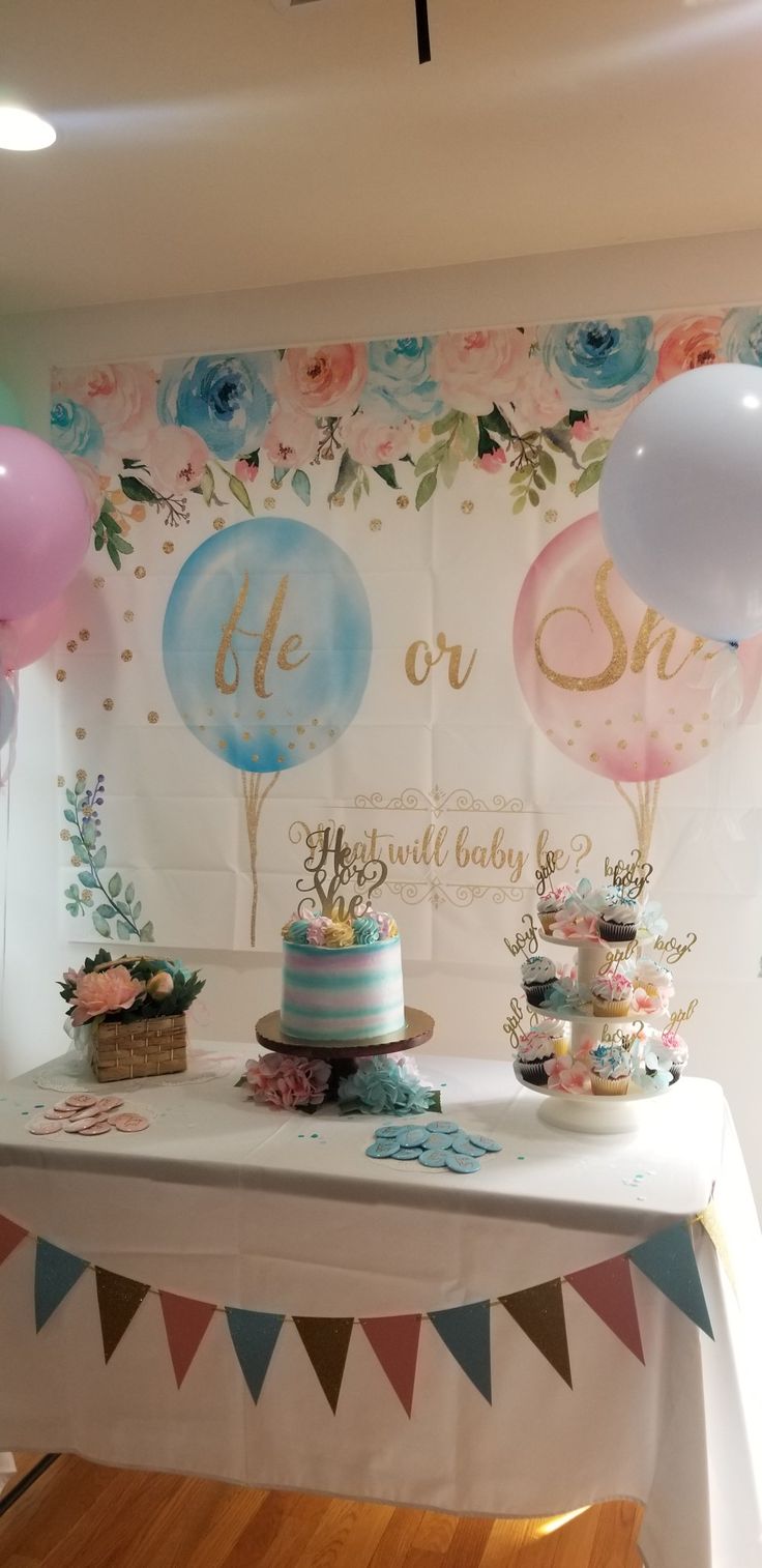 a table with cake and balloons on it