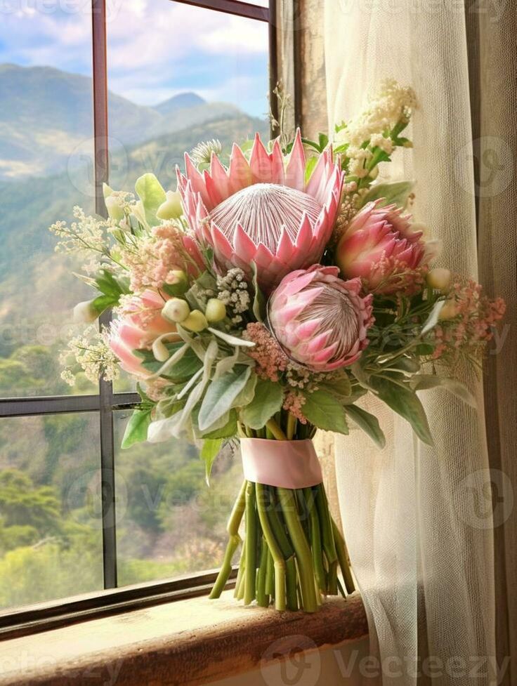 a bouquet of flowers sitting on top of a window sill next to a window