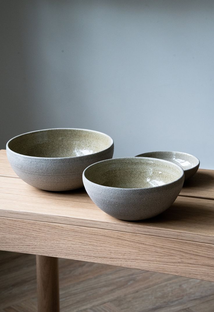 two bowls sitting on top of a wooden table