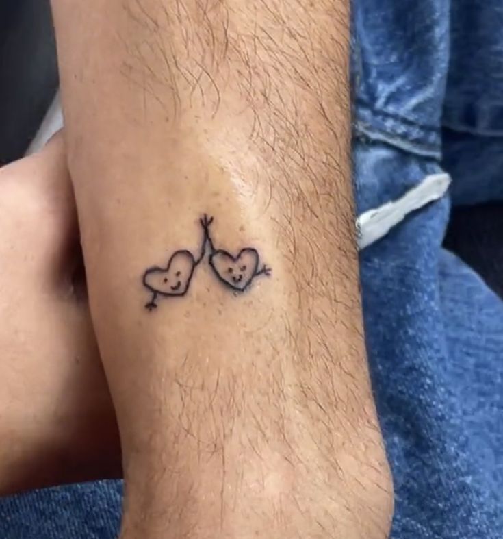 a couple of small hearts on the ankle with an arrow and two smaller hearts in the middle